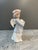 Handcrafted in Spain, this porcelain figurine depicts a beautifully serene young angel tenderly cradling a small rabbit....