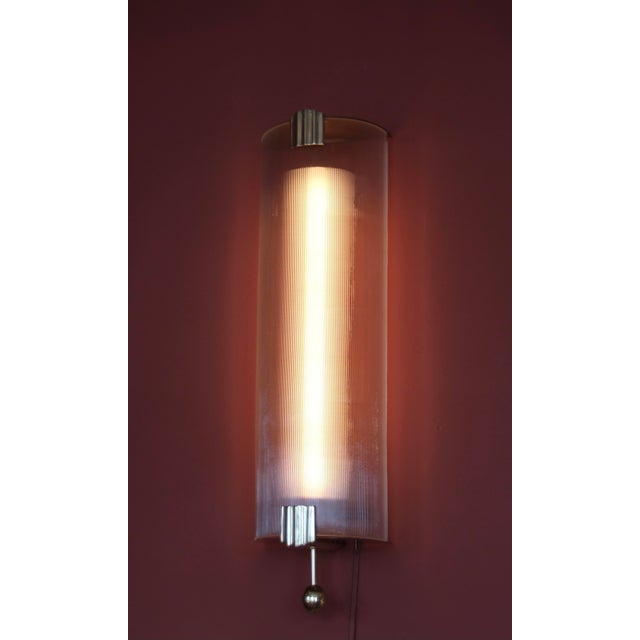 This French wall light probably comes from a cinema or hotel. The very elegant and reduced form consists of a pleated...