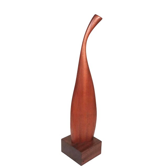 Mid Century organic sculpture of solid teak, an a rectangular mahogany plinth base. This elegant piece is in excellent,...