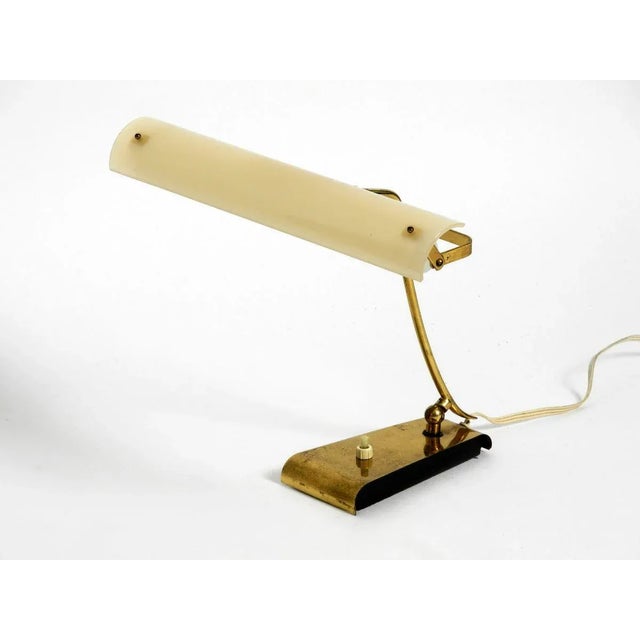 Very rare mid century modern brass table lamp with a movable acrylic glass shade. the entire lamp is made of brass. With a...