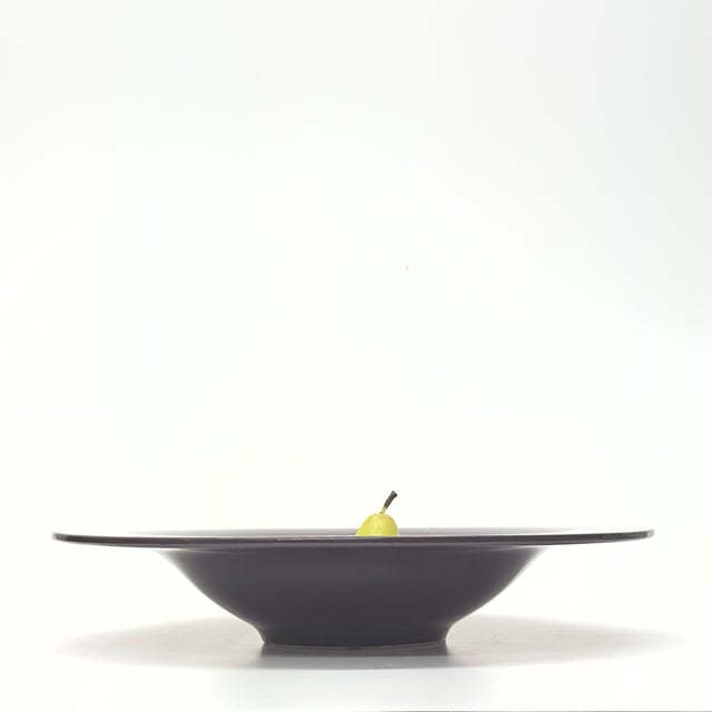 Purple ceramic bowl. This 1980s rare statement piece is a stunning aubergine-purple large ceramic pedestal bowl by Royal...