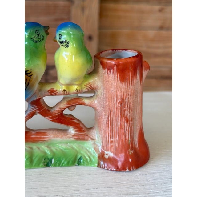 Charming Mid-20th Century hand-painted ceramic planter featuring three colorful budgerigars perched on a branch between...