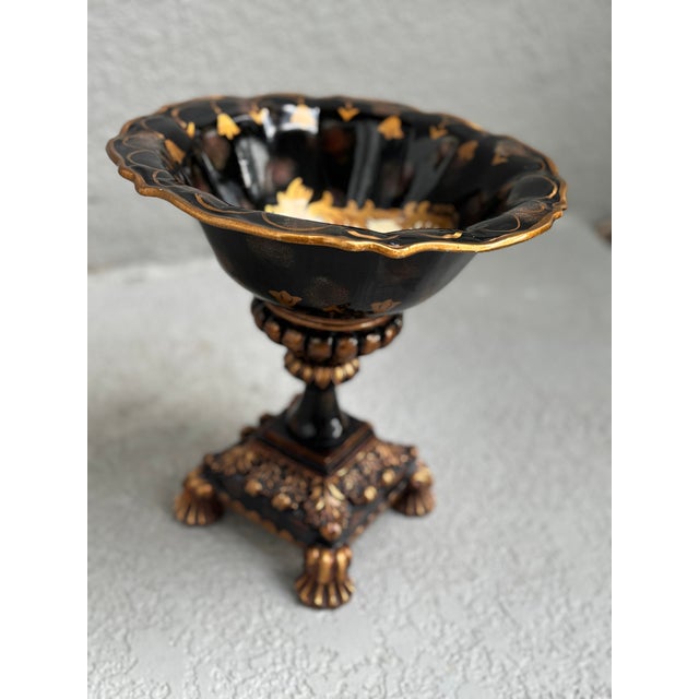 This vintage, exquisite decorative bowl features a dramatic black lacquer-style finish highlighted with rich gold accents...