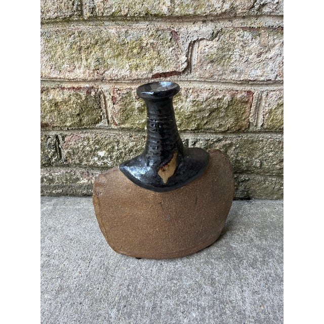 Vintage decorative pottery, 1960s-1970s. Shaped like a flask with a dark, glossy glazed neck, this pottery piece has a...