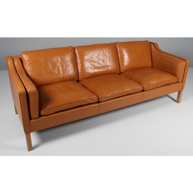 Børge Mogensen three-seat sofa with original cognac leather upholstery. Legs of oak. Model 2213, made by Fredericia...