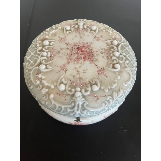 The Decorative, ornate Victorian Era Glass Dresser Box has a hand painted floral design with a beveled glass hinged cover....