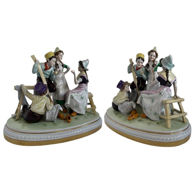 This antique German porcelain figural group portrays four provincial Dutch children in traditional attire gathered in...