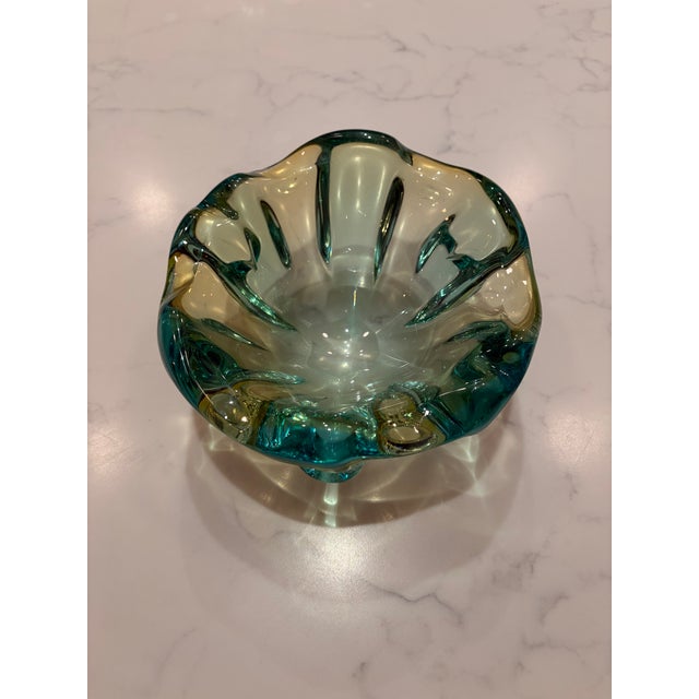 A heavy, vintage art-glass bowl in luminous shades of emerald green, aqua and deep turquoise. Its thick, substantial glass...
