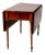 An antique wooden drop leaf table featuring a warm, richly toned finish and a versatile rectangular form. The table...