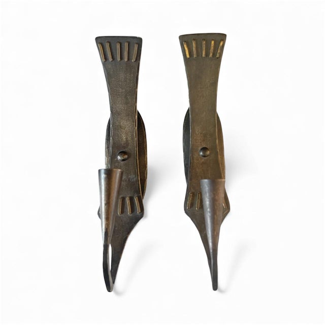 A striking pair of rare mid-century Scandinavian wall sconces by Swedish metal artisan Lars Holmström for Arvika. Crafted...