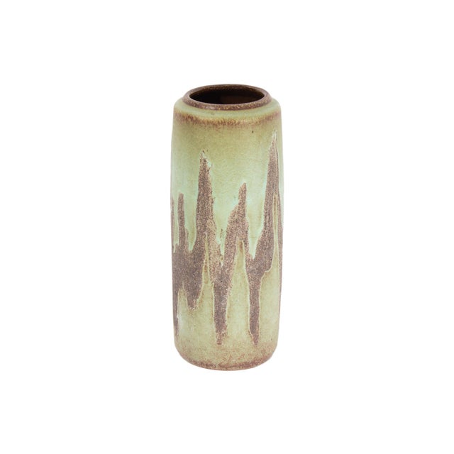 A West German ceramic vase produced by Scheurich Keramik. This mid-century vase is cylindrical in shape and has a green...