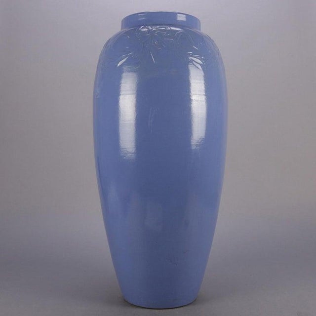 Pair of Arts & Crafts McCoy School art pottery floor vases feature collar with embossed swags and bows and periwinkle blue...