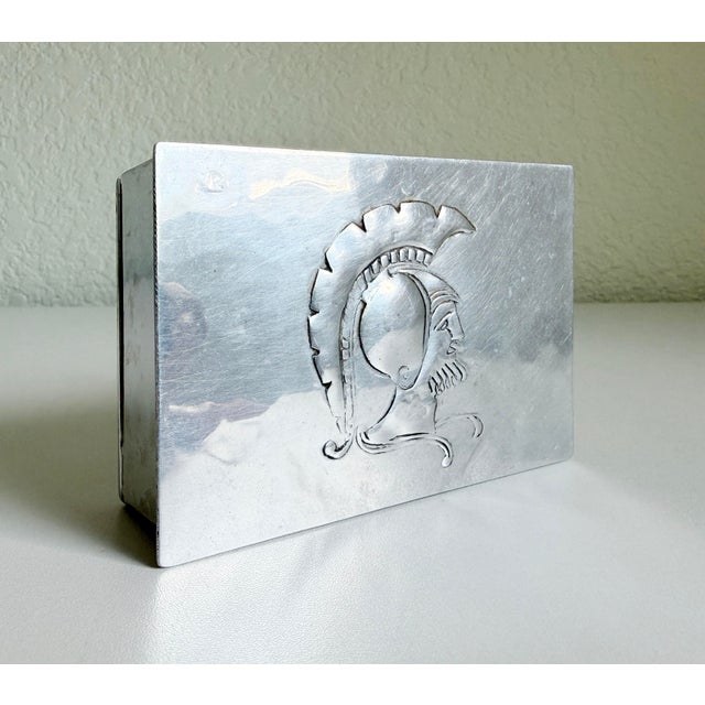 A handsome vintage silver-finish box featuring an embossed Roman gladiator motif on the lid. Rectangular in form with a...