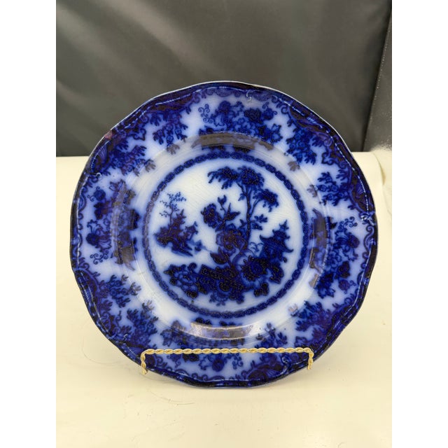 2 Antique flow blue plates marked 'Rhoda Gardens II' on the underside. Featuring a floral and landscape design with...