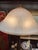 gorgeous art nouveau lamp with glass shade and floral carved design on base.