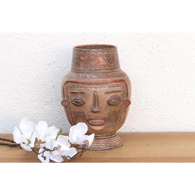 The Chancay clay pot is a sophisticated exploration of ancient Andean ceramic form. This hand-modeled terracotta vessel is...