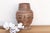 The Chancay clay pot is a sophisticated exploration of ancient Andean ceramic form. This hand-modeled terracotta vessel is...