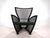 A Prive armchair with black metal weave and black leather trim in excellent condition. The armchair shows only minimal...