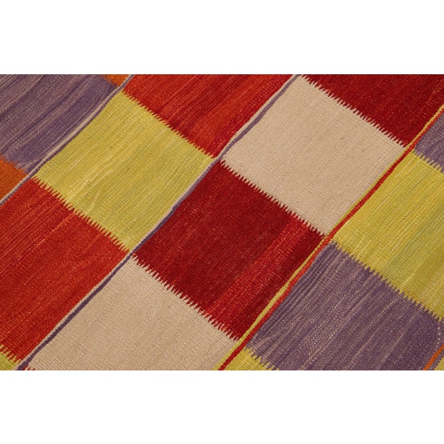Beautiful Modern Kilim hand-knotted wool rug with multicolor accents in an all-over geometric design. This rug measures...