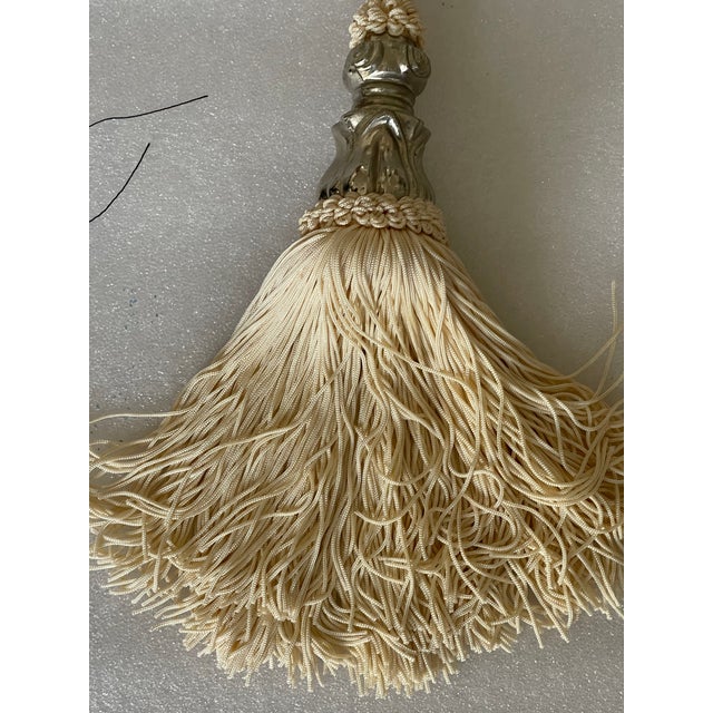 Two black and white silk Tiebacks with tassels.