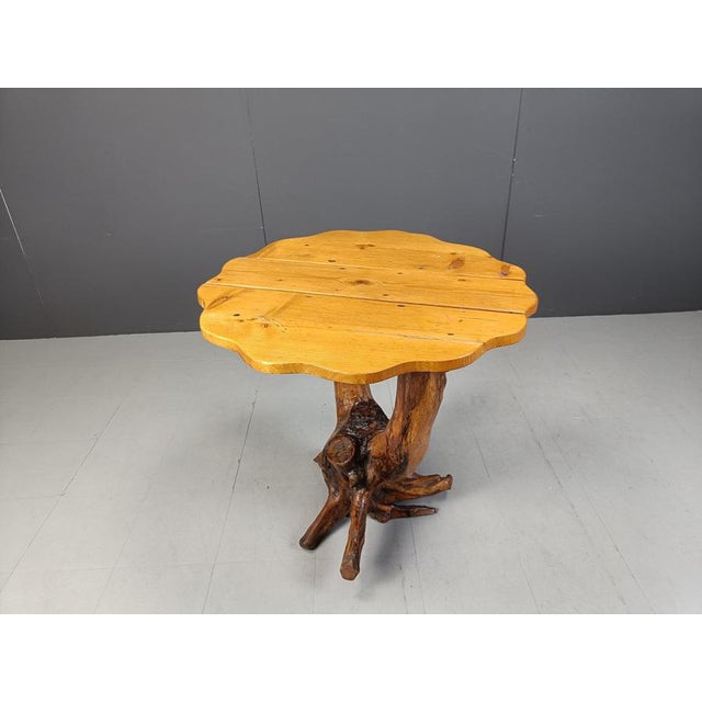 Fantastic looking tree root table with a sculpted table top. This table is really designed by nature. Striking piece for...