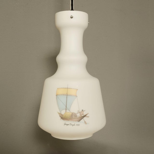 Beautiful pendant chandelier, 1950s, in white opaline glass, with decorations of the three caravels. Equipped with black...