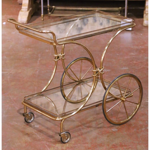 This elegant vintage French bar cart, crafted circa 1950, showcases refined mid-century design in a warm gilt-brass...