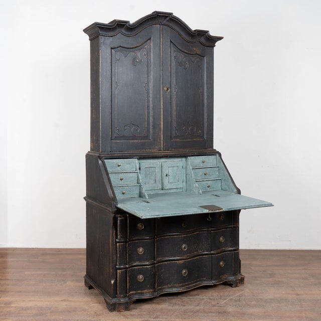 18th century Danish secretary, crafted in oak. Hand carved panels decorate the two upper cabinet doors, while graceful...