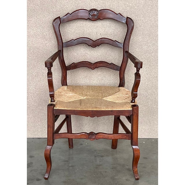 19th century Spanish carved armchairs with original rush seat. Fantastic undisturbed surface with worn arms. Super...