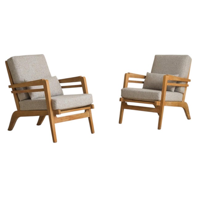 Crafted in the manner of René Gabriel, this textured lounge chair, complemented with a throw pillow presides from France...