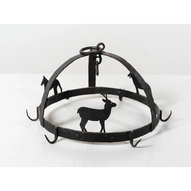 Hand-wrought iron hanging butcher's display adorned with three animal silhouettes and six meat hooks. Belgium Circa 1920