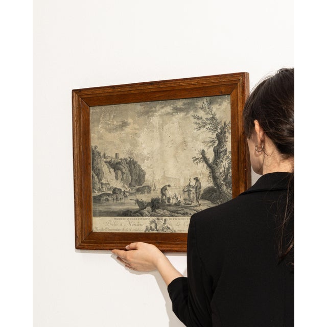 This 19th century print from France is an engraving, housed in a wood and glass frame. Its form follows honest, well-...