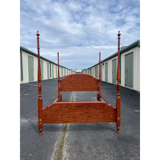 A queen size cherry poster bed frame made by Broyhill. Classic and timeless design displays four prominent posts on each...