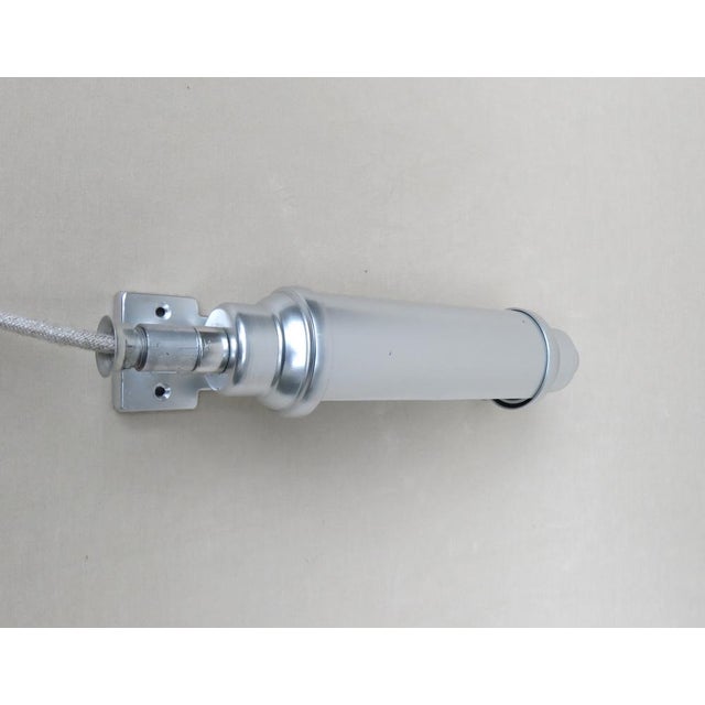 A minimalist wall light "submarine light" from the 30s/40s polished in aluminum. The lamp has a version E27. The umbrella...