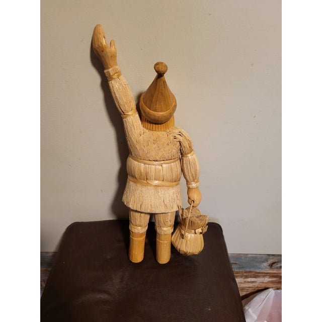 This product is a vintage hand-carved wooden statue of Santa Claus in a folk art style. The statue features intricate...