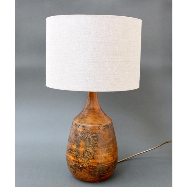 Mid-century ceramic table lamp (1974) by jacques blin. A beautifully burnt-orange hued lamp and sgraffito-etched harp with...