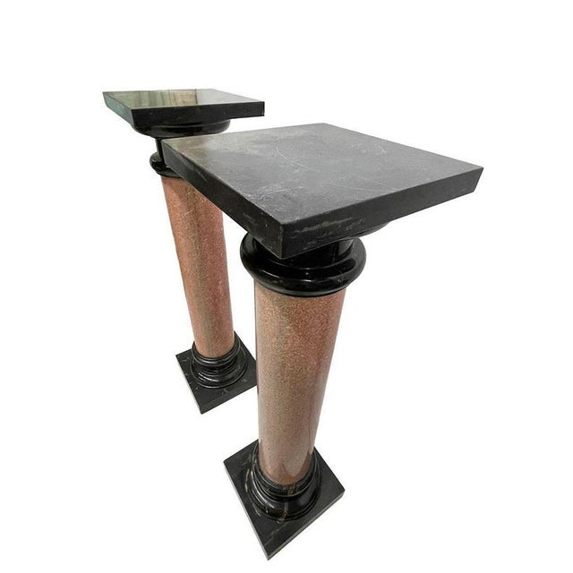 Two marble columns, 20th century Two marble columns, 110 cm high, with a black top and bottom section and a beautiful...