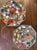 Pair of vintage handmade stepping stones featuring colorful mosaic glass fragments set into solid concrete bases. Each...