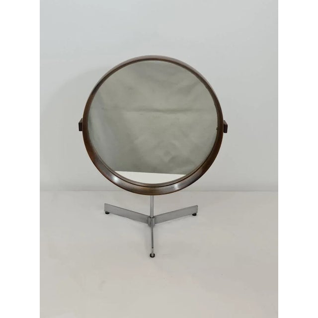 Table mirror in rosewood by Uno and Osten Kristiansson manufactured by Luxus Sweden around 1960. Circular mirror with...