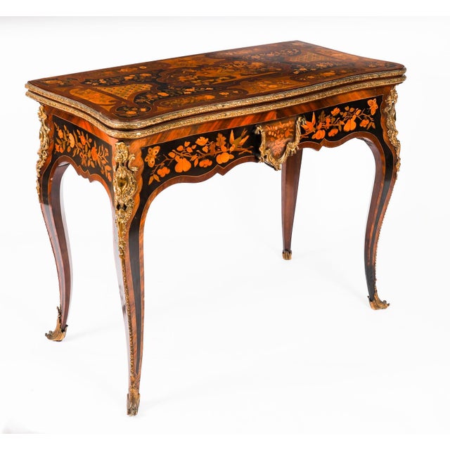 This is a beautiful antique French Louis XV Revival ormolu mounted king wood, burr walnut and floral marquetry shaped...