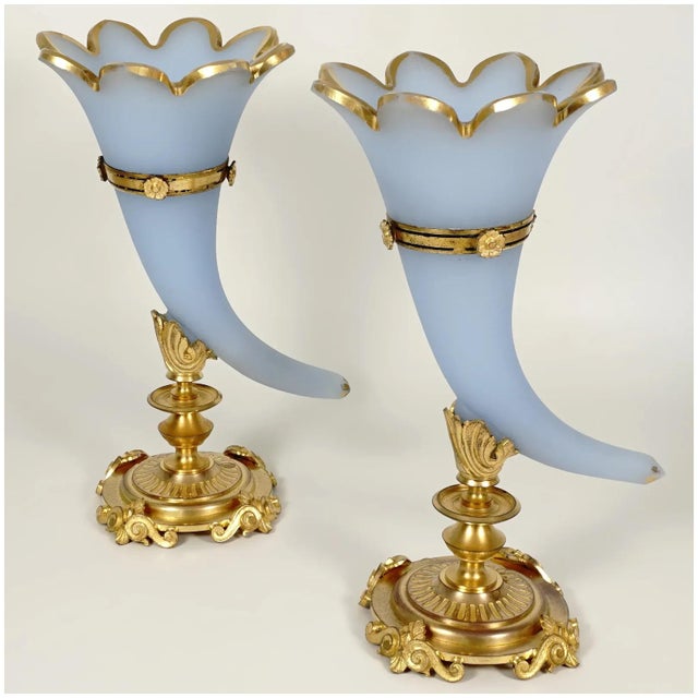 Stunning antique pair of French Charles X era cornucopia vases. Featuring blue opaline glass cornucopia horn vases mounted...