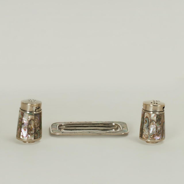 Rousing salt and pepper shaker with tray, handcrafted in silver plate on hammered copper decorated in mother of pearl....