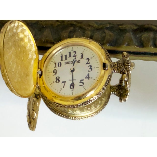 Vintage Brigade quartz pocket watch with an ornate Art Nouveau-style case featuring a high-relief portrait of three...