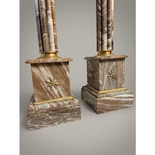 Bring classic sophistication to your home with this striking pair of neoclassical-style veined marble columns. Crafted...
