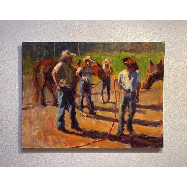 In "Morning Riders," figures gather in a sunlit setting, engaged in the quiet anticipation of a day spent with horses. The...