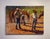 In "Morning Riders," figures gather in a sunlit setting, engaged in the quiet anticipation of a day spent with horses. The...