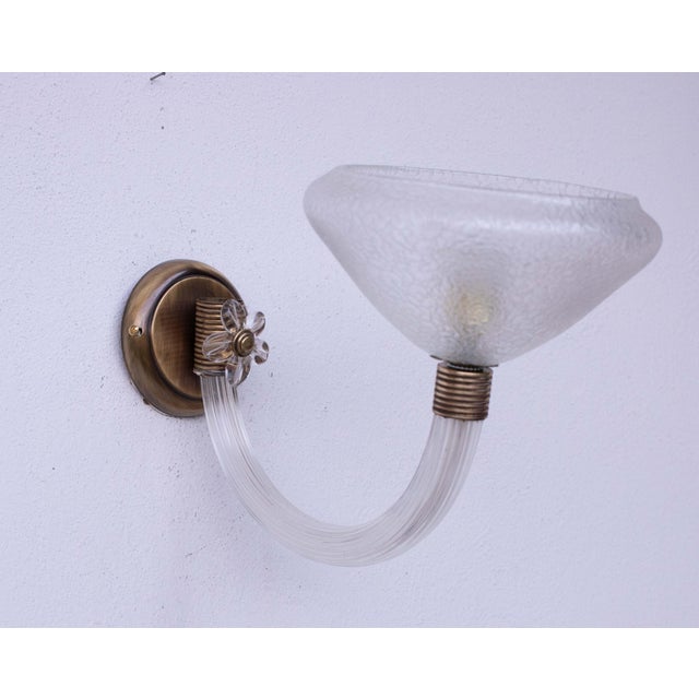 Gorgeous Murano glass wall lamp attributed to the Venini glassworks. Period of production, circa 1960. The light is formed...