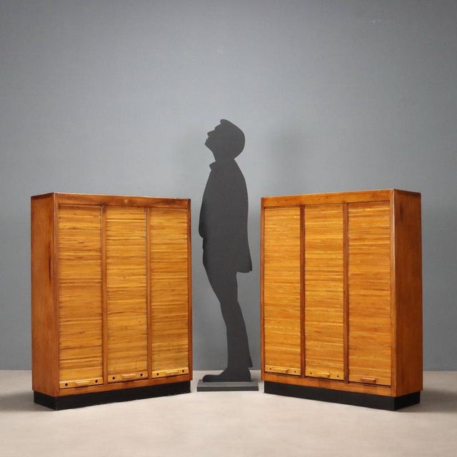 Pair of storage units, with internal shelves, shutter openings, walnut veneer and laminate top. Good condition. This piece...