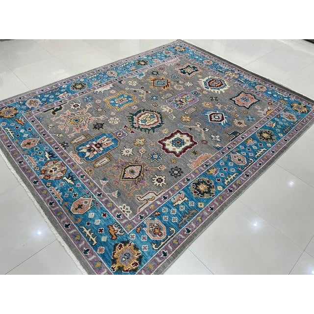 This gray hand knotted pile rug is crafted from wool and features a traditional Nain style aesthetic. Originating from...