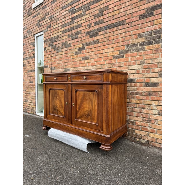 This is a beautiful 19th century French server featuring two drawer above two burled wood doors that opens into storage....